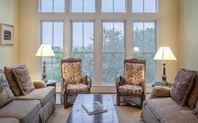Living room couch chairs big windows